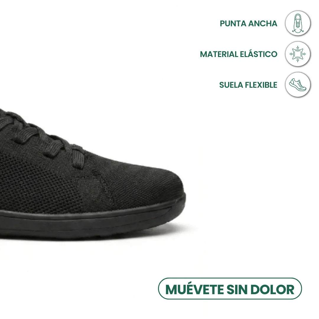 Tæt på den sorte sneakers brede tå med ikoner for bred tåboks, elastisk materiale og fleksibel sål. 14
