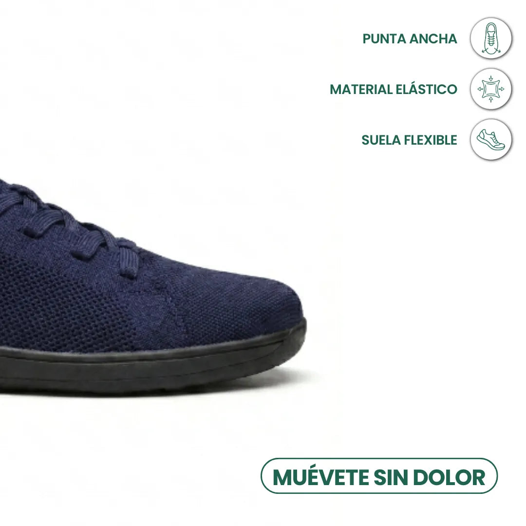 Detalje af den brede tåboks på marineblå mesh-sneaker med sort sål, med ikoner for elastisk materiale og fleksibel sål. 23