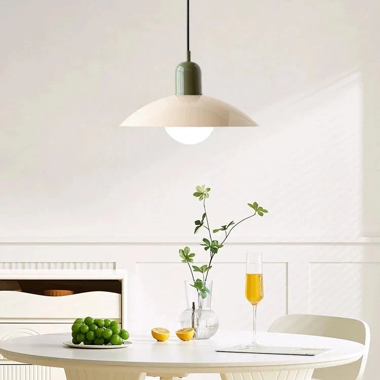 Pendel med mørkegrøn top og cremefarvet skærm over rundt hvidt bord med druer, citron og champagneglas 6