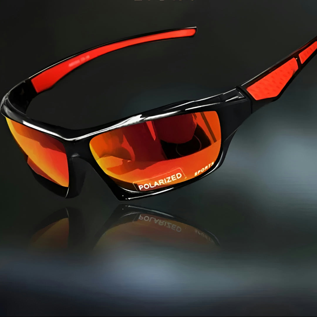 Sportsbrille med orange spejlglas og røde stænger, set skråt fra siden på mørk baggrund 6
