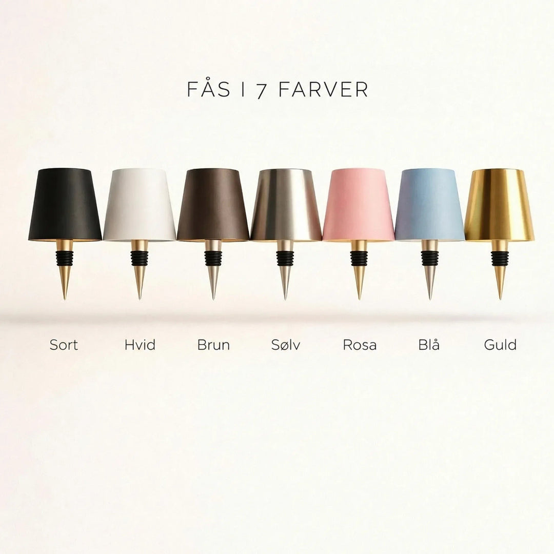 Syv lampeskærme med flaskepropper i række: sort, hvid, brun, sølv, rosa, blå og guld 3