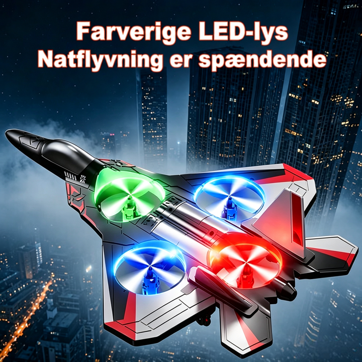 Jagerflyet med lysende grønne, blå og røde propelringer set ovenfra, flyvende over en oplyst storby om natten. 1