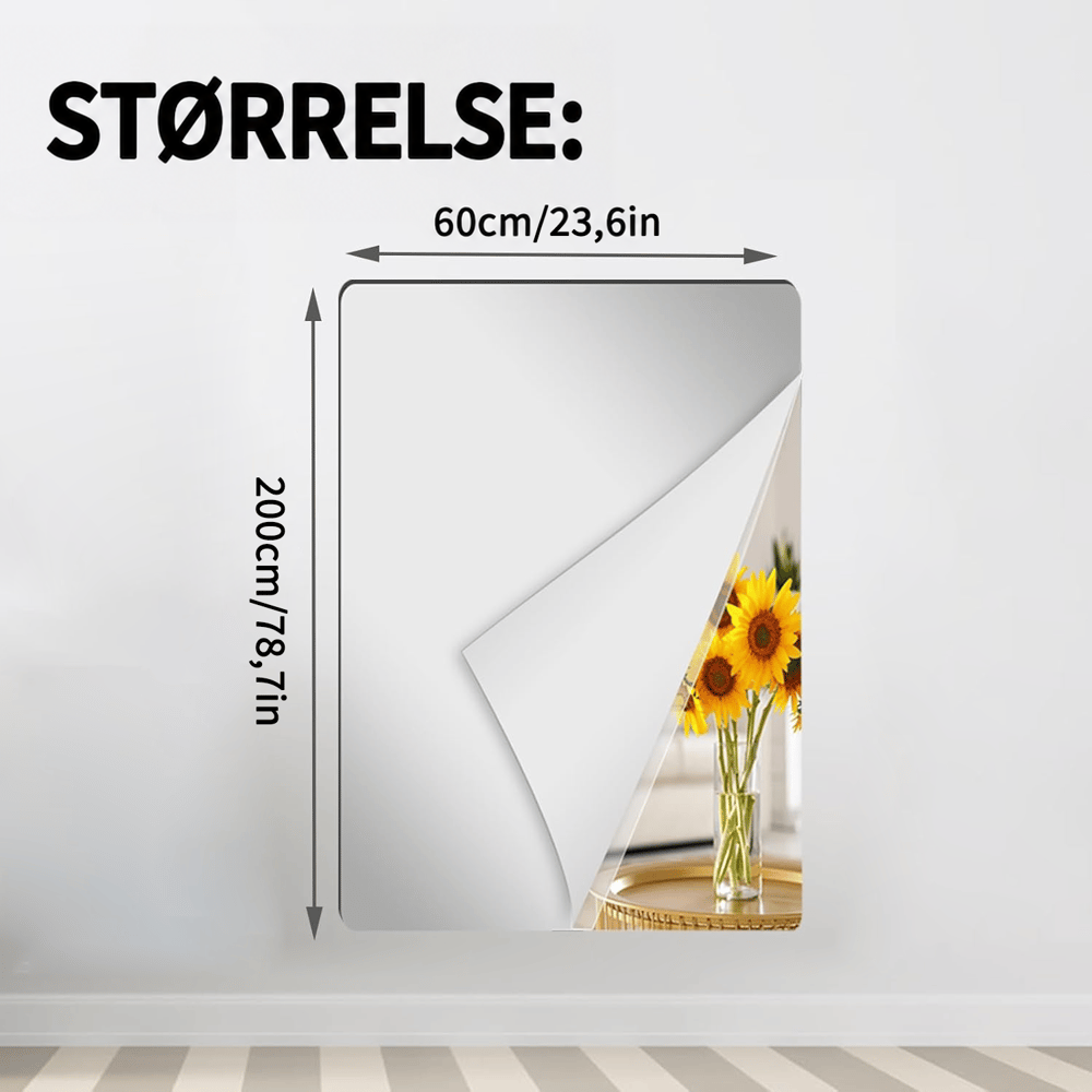 Bredt og højt rektangulært spejlark med oprullet hjørne på en lys væg, der viser solsikker, med målpile for den største størrelse. 15