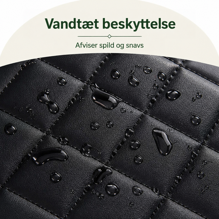 Nærbillede af sort kunstlæderagtig vatteret overflade med vanddråber, der perler af og viser den vandtætte overflade. 3