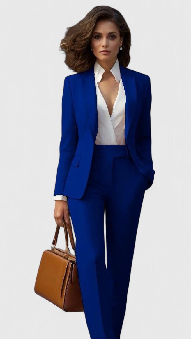 Model i kongeblåt sæt med blazer og bukser med lige ben, hvid skjorte og brun håndtaske. 6
