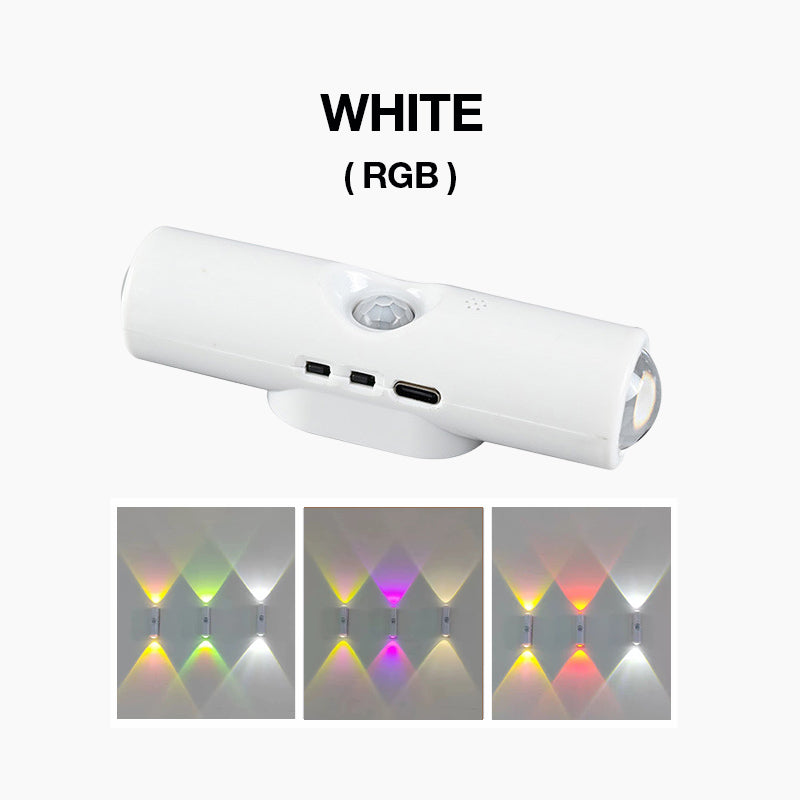 Hvid cylinderformet væglampe med sensor og USB-C-port, med tre eksempler på farveskiftende RGB-lys på væggen 2